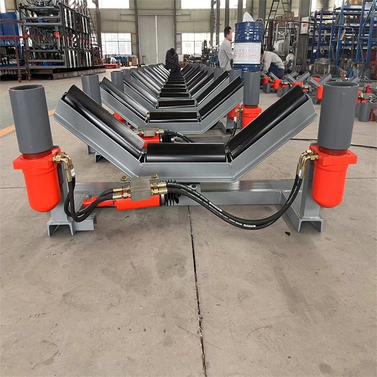 Self-aligning training idler for belt tracking